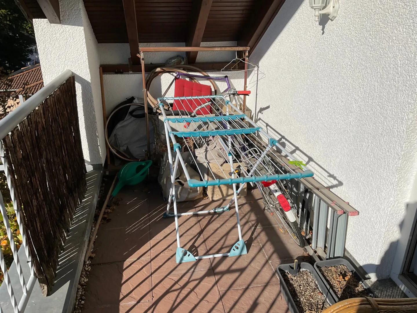 Balkon mit Wäscheständern und weiteren Gegenständen vor der Dachgeschossräumung